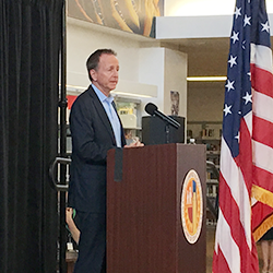 Superintendent Austin Beutner speaking at a podium at RFK Community Schools in Los Angeles.  