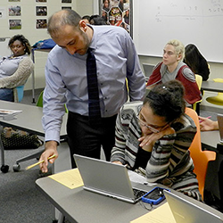 A teacher helping a student. 