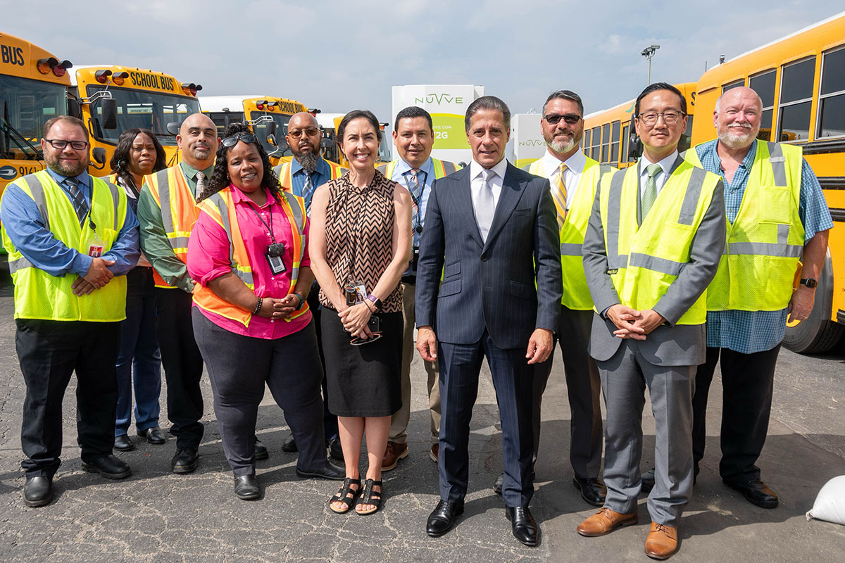 Group photo at the Gardena Bus Yard in front of electric buses and chargers