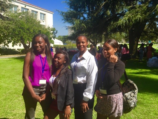  Female students and teacher attending leadership conference